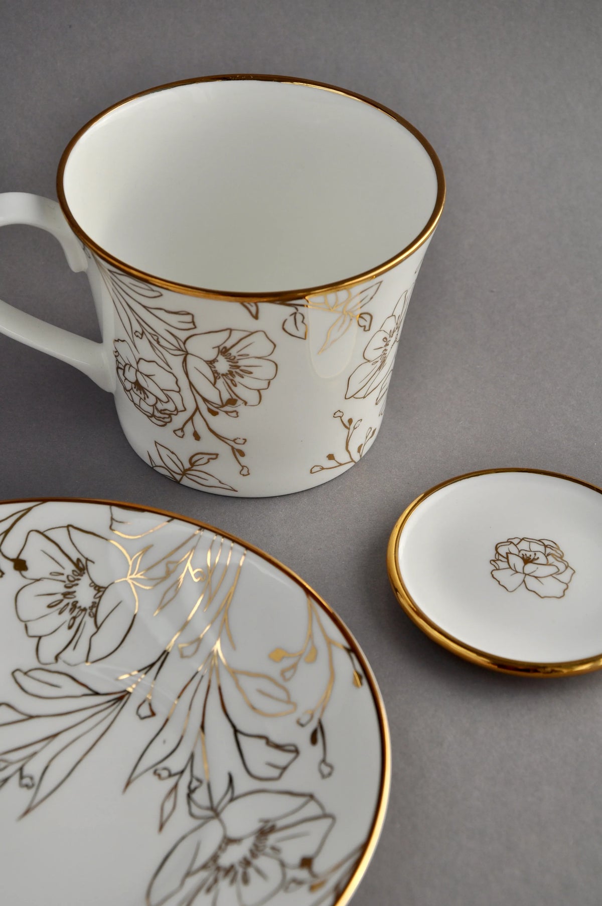 Blossom gilded tea table setting with a cup and saucer