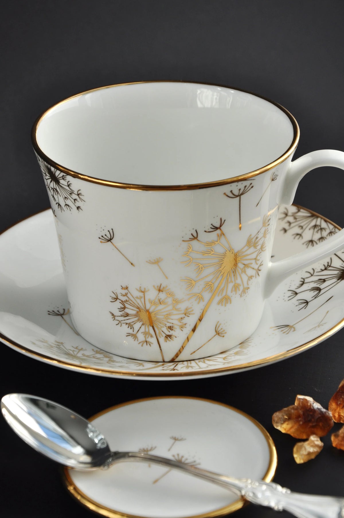 Dandelion trinket dish used as a teaspoon rest beside a matching fine bone china cup and saucer