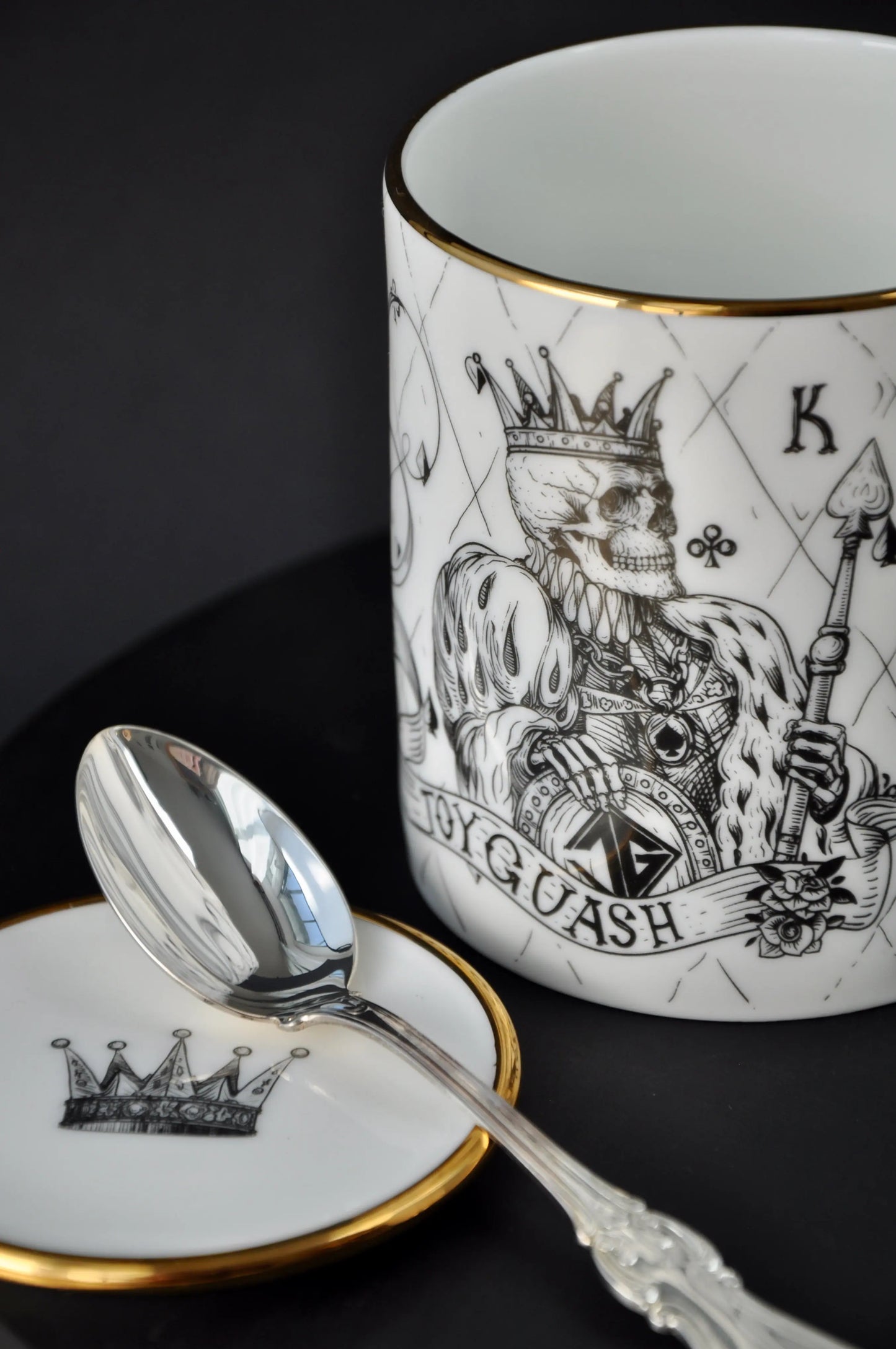 Small fine bone china dish holding a teaspoon beside a matching mug