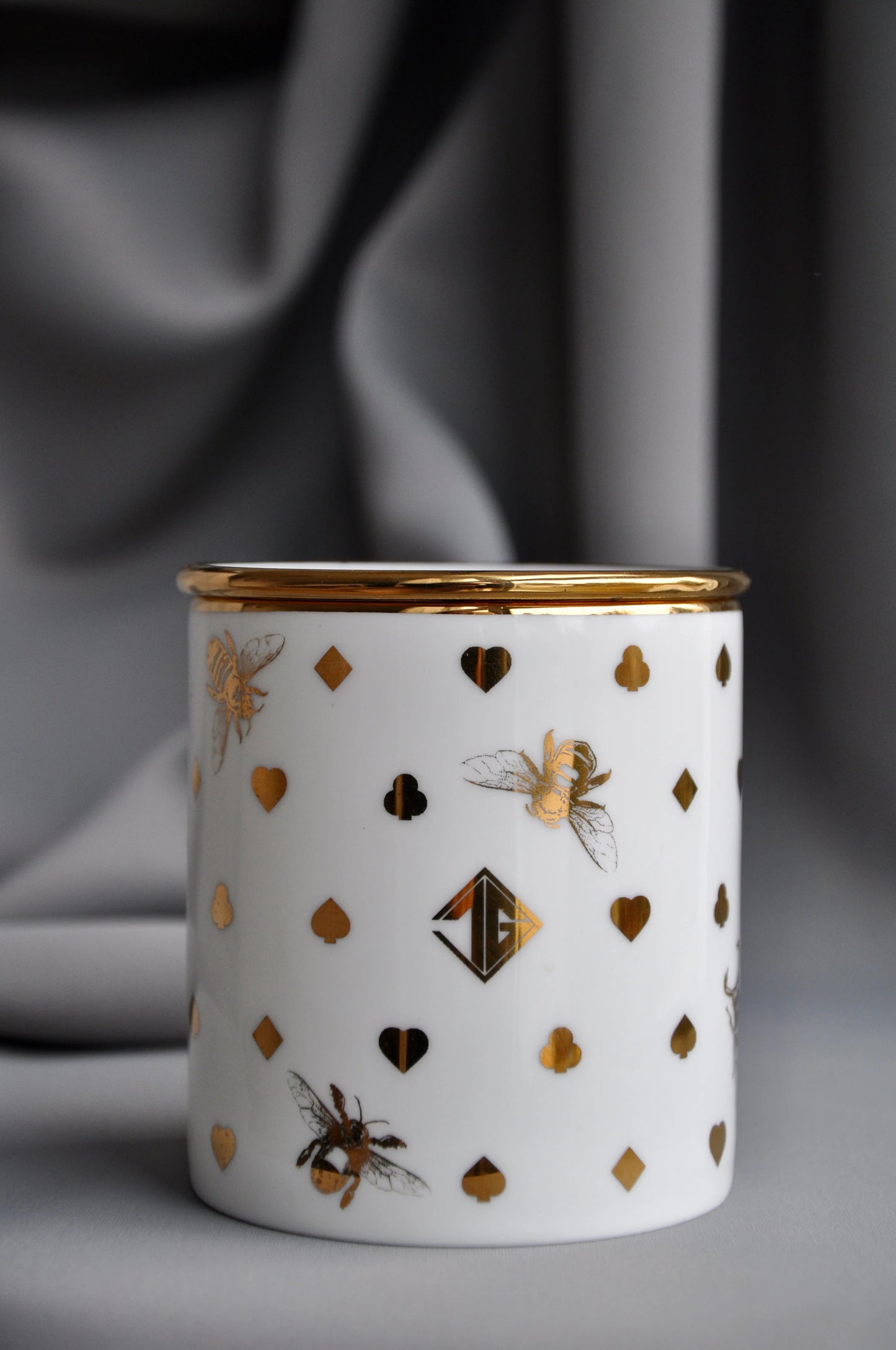 Fine bone china vessel with a coordinating lid, converted into a decorative storage pot.