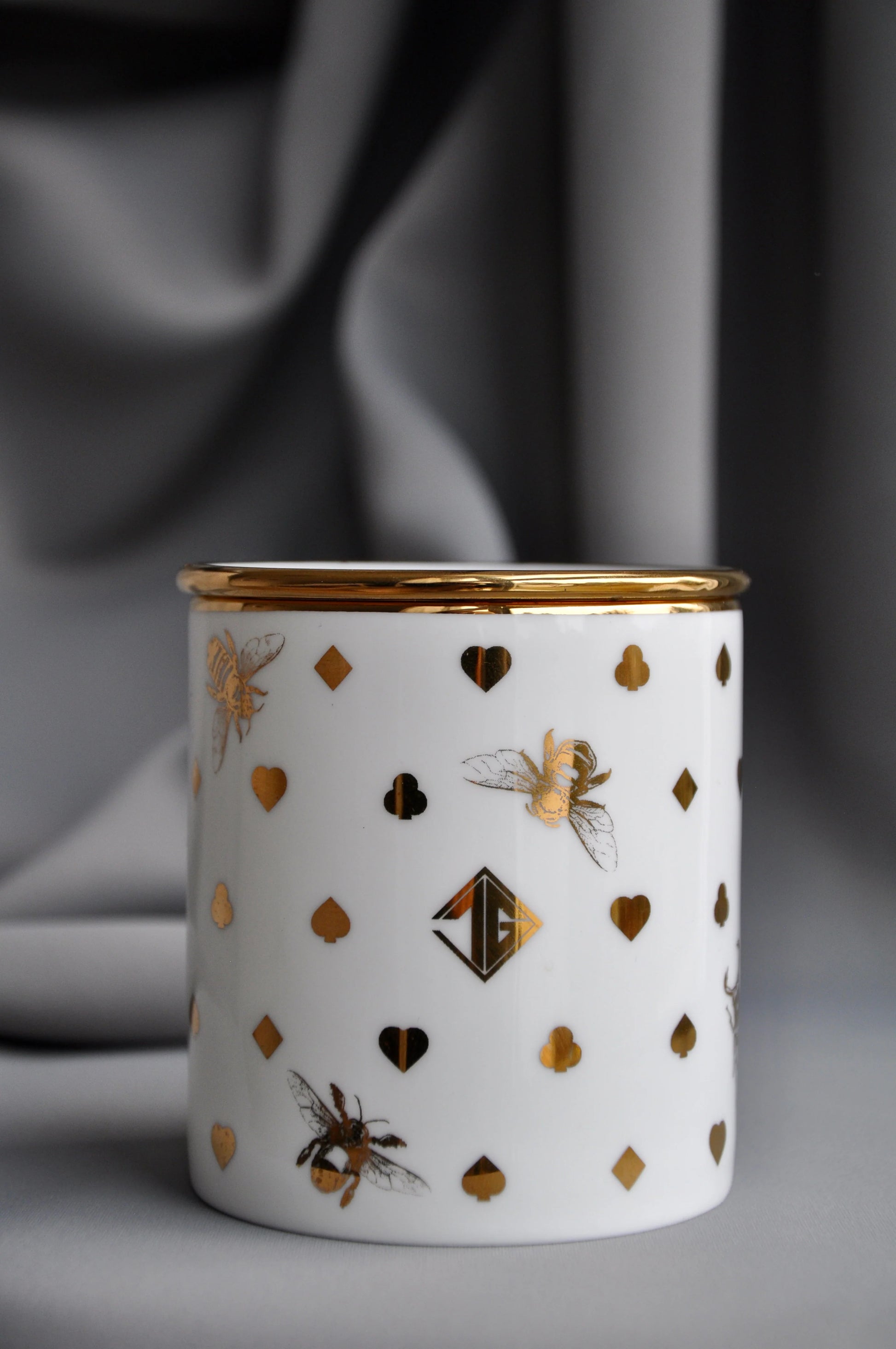 Fine bone china vessel with a coordinating lid, converted into a decorative storage pot.