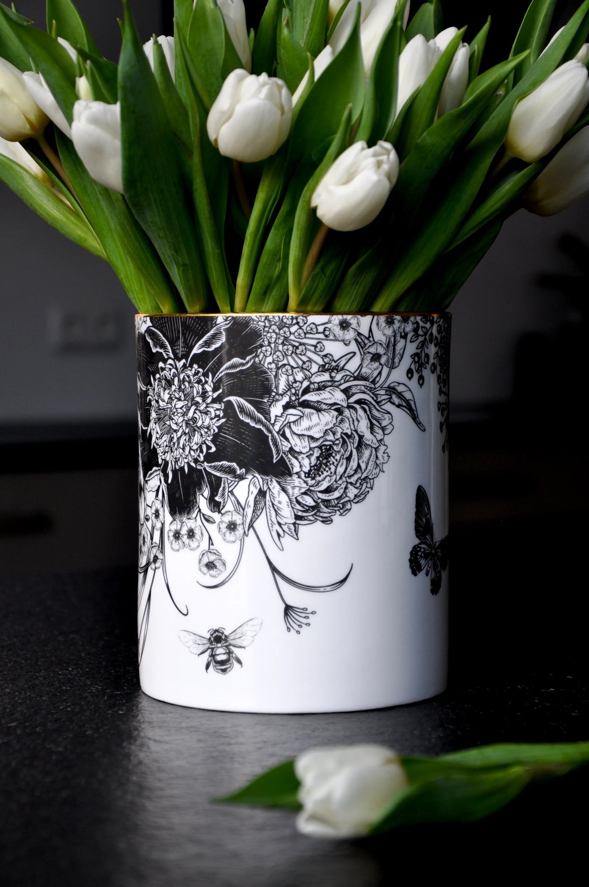 Botanicals ceramic cylinder vessel styled with a lush bouquet of fresh white tulips