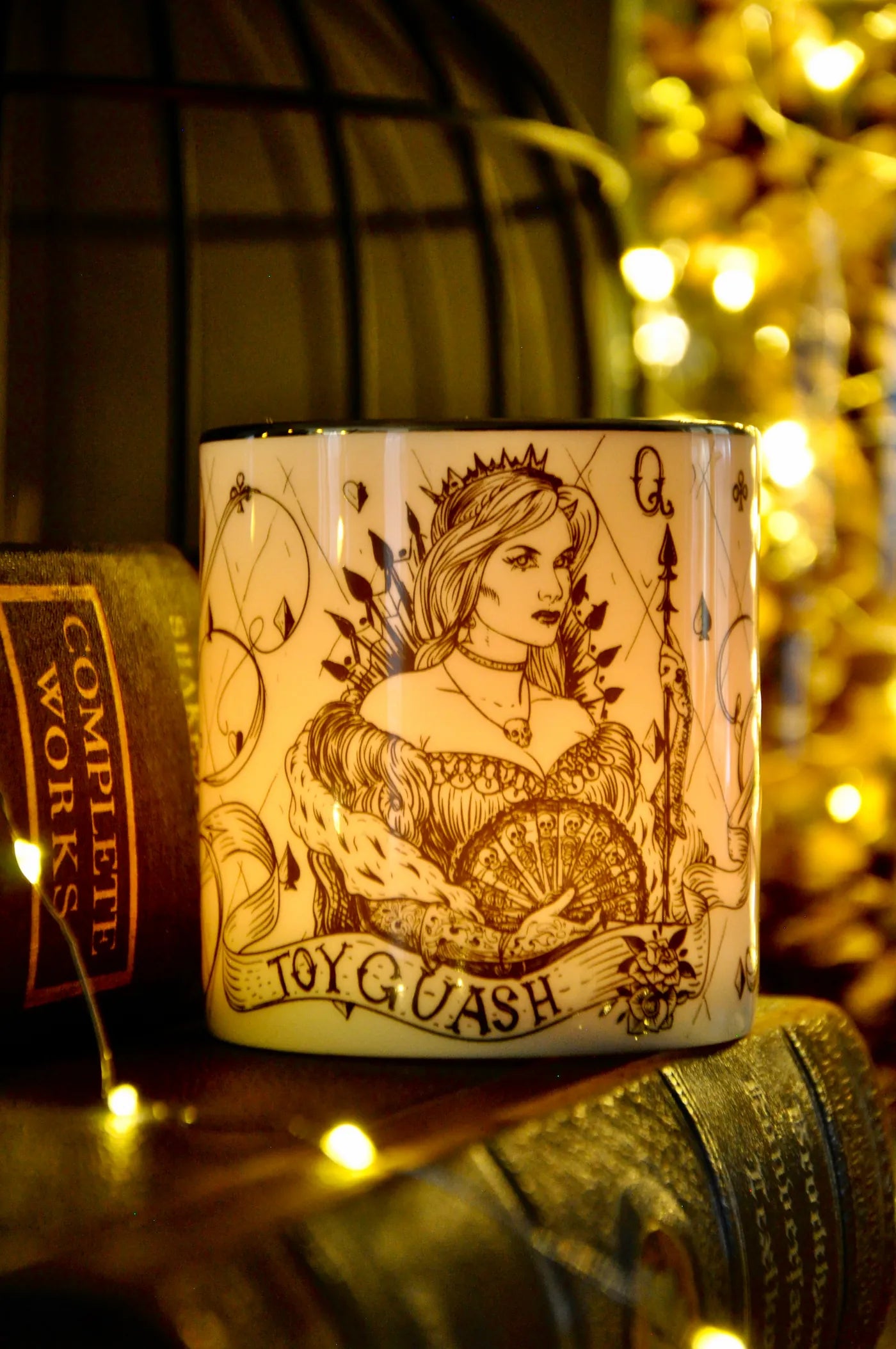 Lit pomegranate candle showing soft light glowing through translucent fine bone china