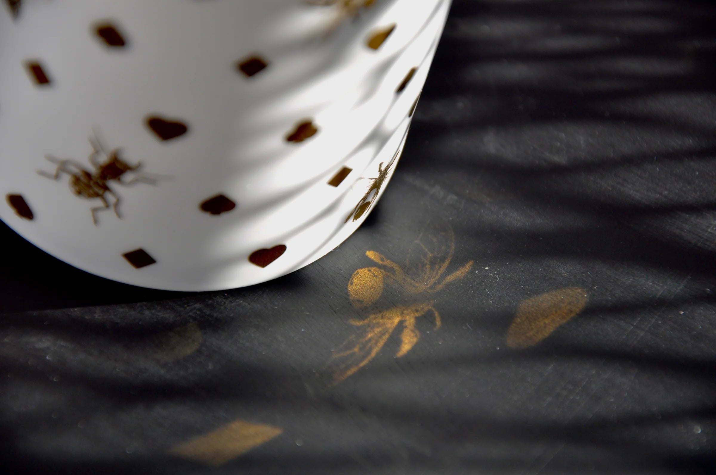 White fine bone china with gold detail and reflection